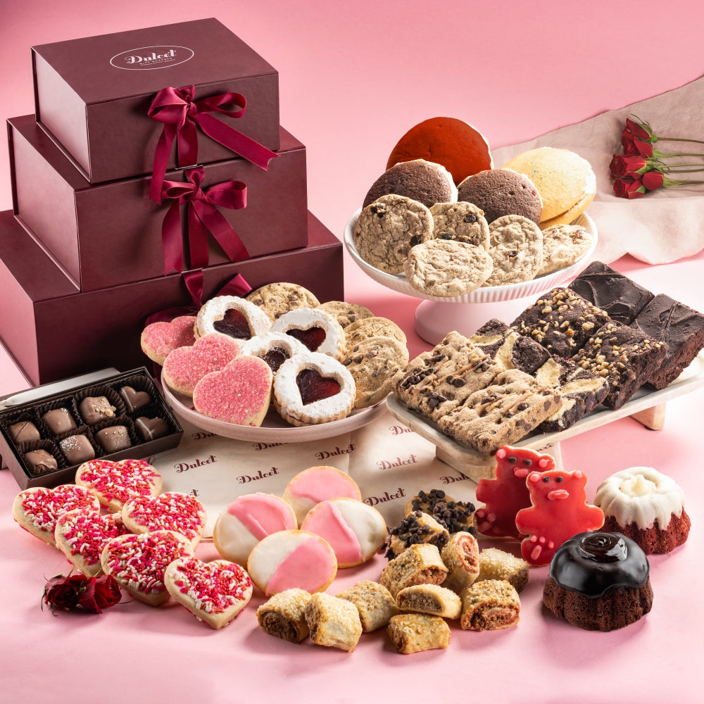 Assorted cookies and chocolates displayed on a pink surface with a Daidel box.